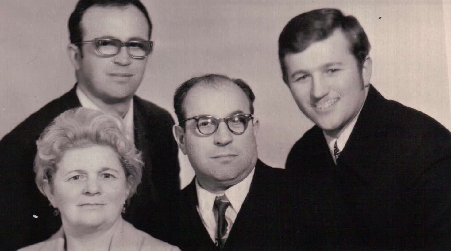 Studio family portrait: Masha, Alexander, and both sons as young men.